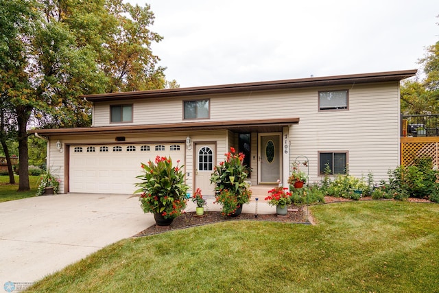 view of front of home with a front yard and a garage