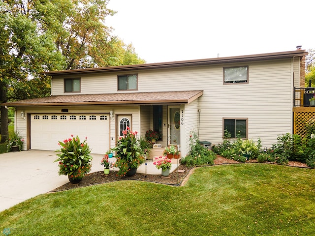 view of front of home featuring a front yard and a garage