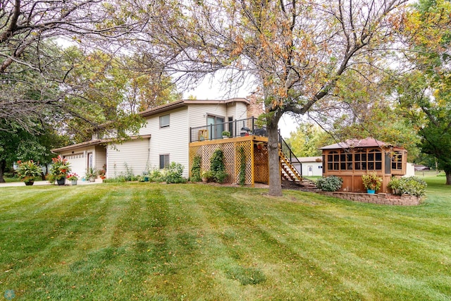 view of front facade with a wooden deck, a garage, and a front lawn