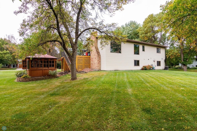 rear view of house with a lawn