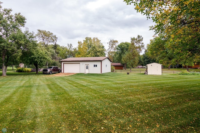 view of yard with a storage unit and a garage