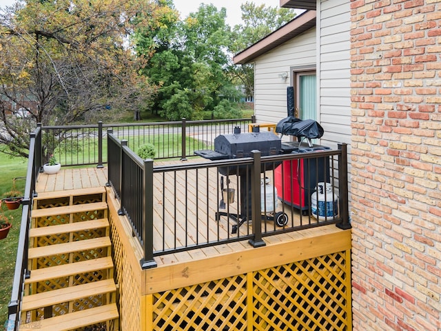 wooden deck featuring a grill