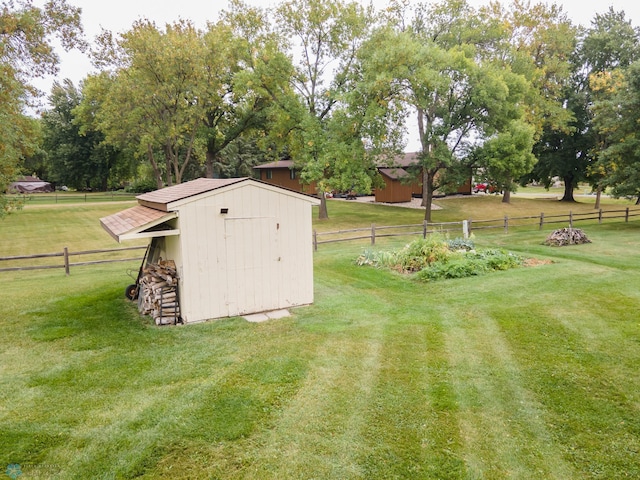 view of yard with a storage unit and a rural view