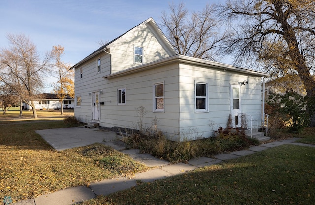 view of side of property with a lawn