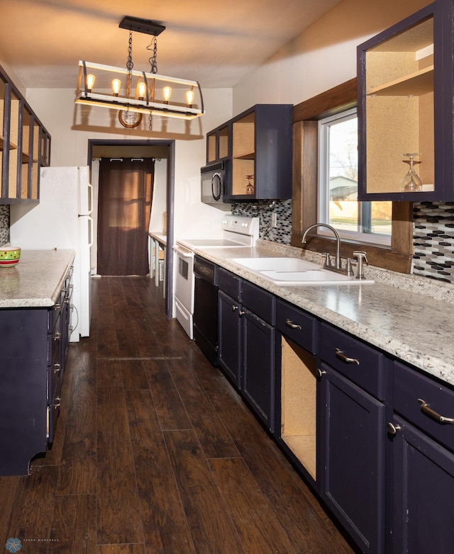 kitchen featuring black appliances, decorative light fixtures, sink, and dark hardwood / wood-style flooring