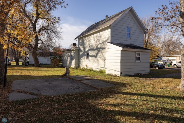 view of side of property with a yard