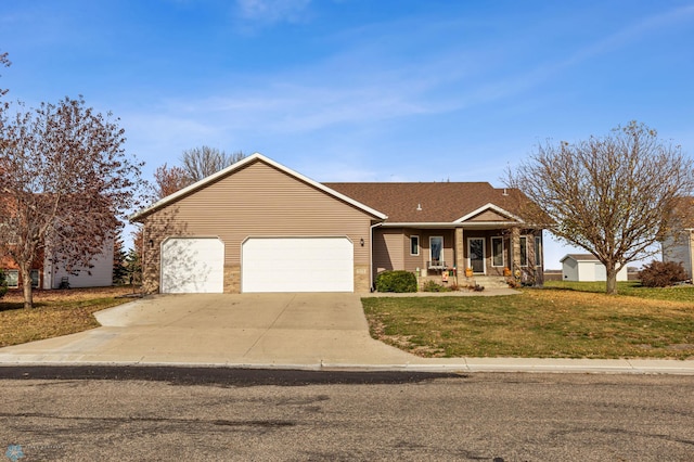 view of front of property with covered porch, a front yard, and a garage