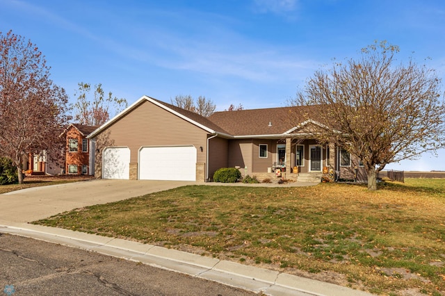 ranch-style house featuring a porch, a front lawn, and a garage