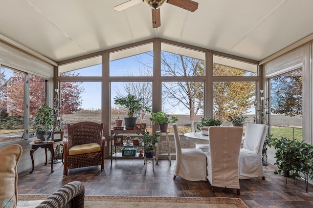 sunroom featuring ceiling fan and vaulted ceiling