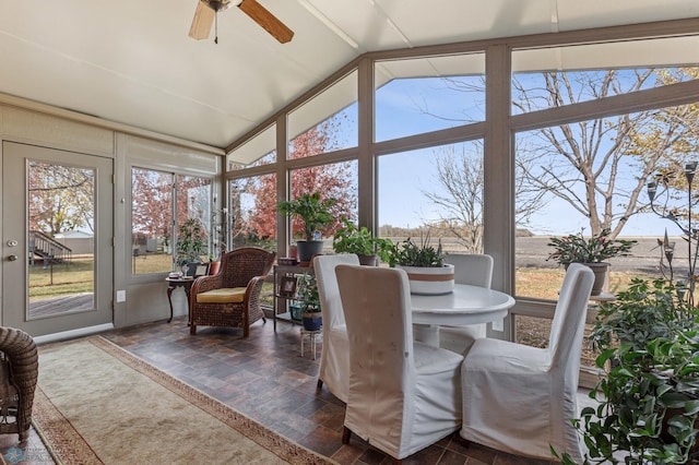 sunroom with ceiling fan and lofted ceiling