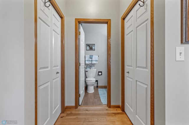 corridor with light hardwood / wood-style flooring