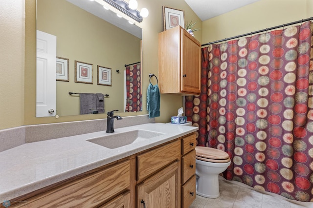 bathroom with vanity, toilet, and tile patterned flooring