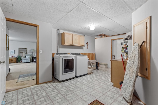 laundry room featuring cabinets, separate washer and dryer, and light colored carpet