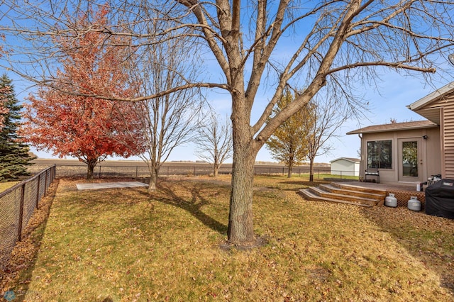 view of yard with a wooden deck and a rural view