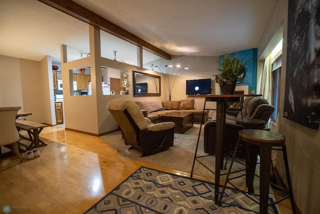 living room featuring lofted ceiling with beams