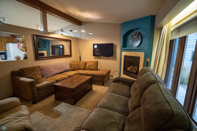 carpeted living room featuring vaulted ceiling with beams