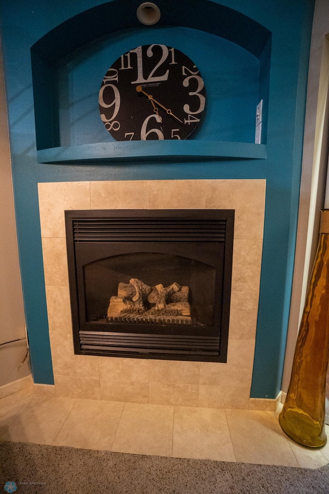 interior details featuring tile patterned floors and a tile fireplace