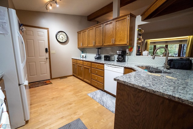 kitchen with white appliances, light stone countertops, sink, decorative backsplash, and light hardwood / wood-style flooring