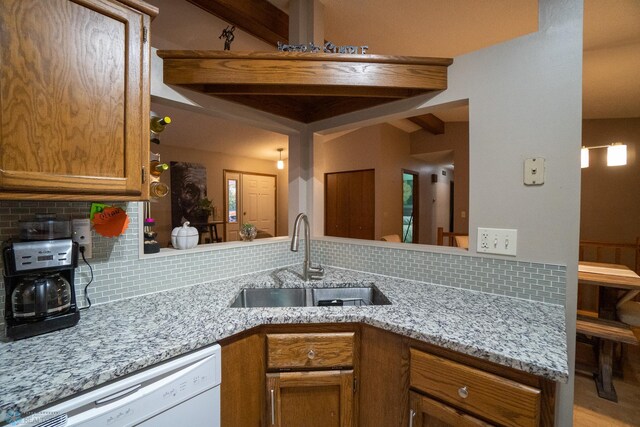 kitchen featuring beam ceiling, white dishwasher, sink, light stone counters, and tasteful backsplash