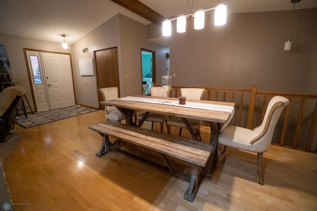 dining room with light hardwood / wood-style floors and lofted ceiling