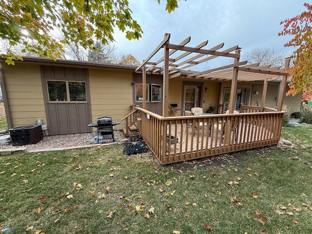 rear view of house with central air condition unit, a wooden deck, a lawn, and a pergola