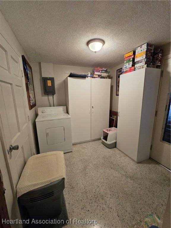 laundry room with washer / dryer, electric panel, and a textured ceiling