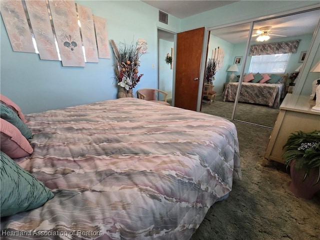 carpeted bedroom with ceiling fan and a closet