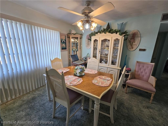 carpeted dining room with ceiling fan