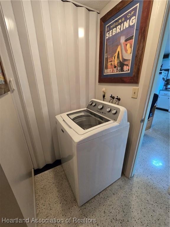 clothes washing area with washer / dryer