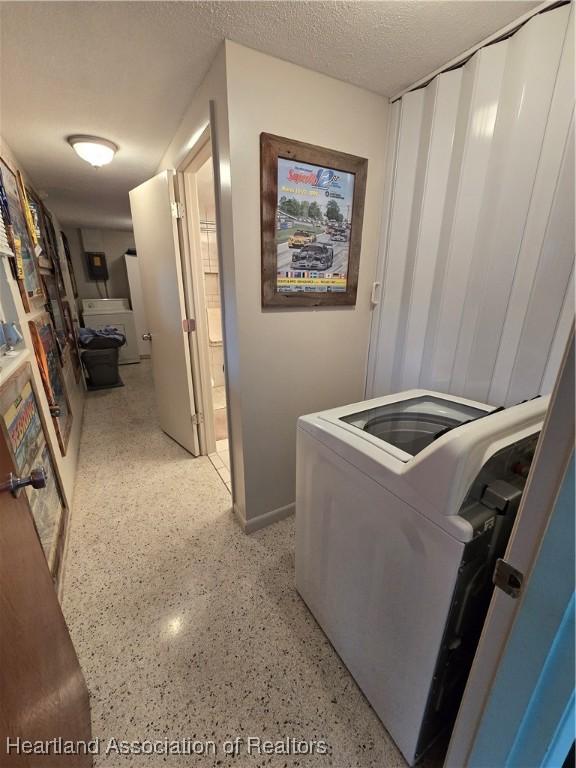 laundry room with washer / clothes dryer and a textured ceiling