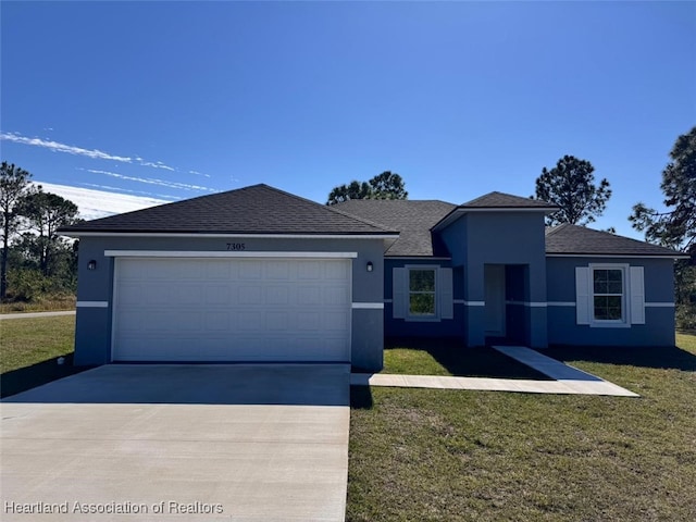 view of front of house with a garage and a front yard