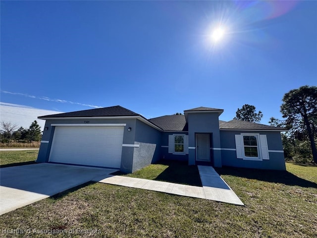 view of front of property with a garage and a front lawn