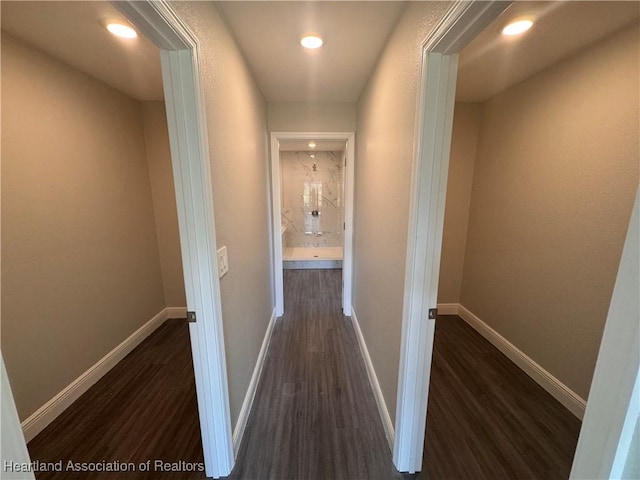 hallway with dark hardwood / wood-style floors