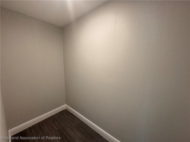 unfurnished room with dark hardwood / wood-style floors