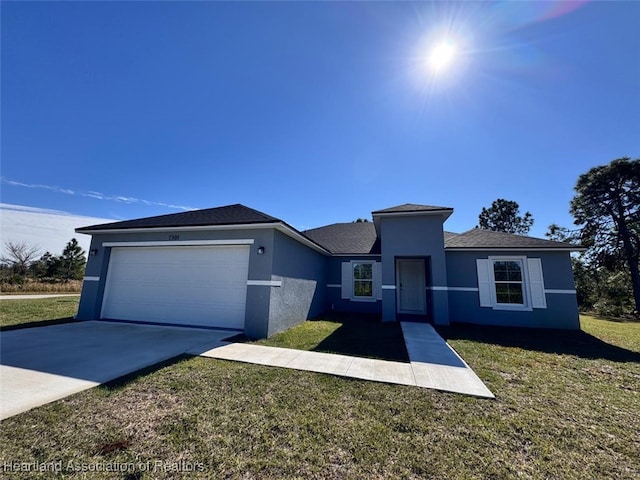 view of front of home featuring a garage and a front yard