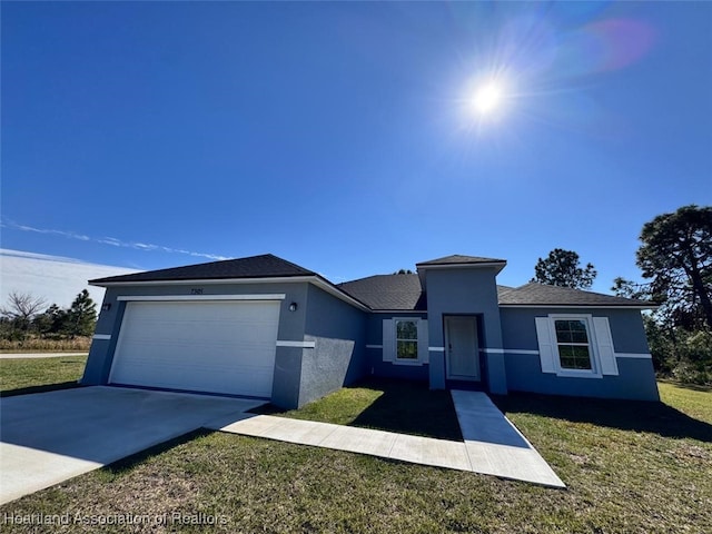 view of front of home with a garage and a front yard