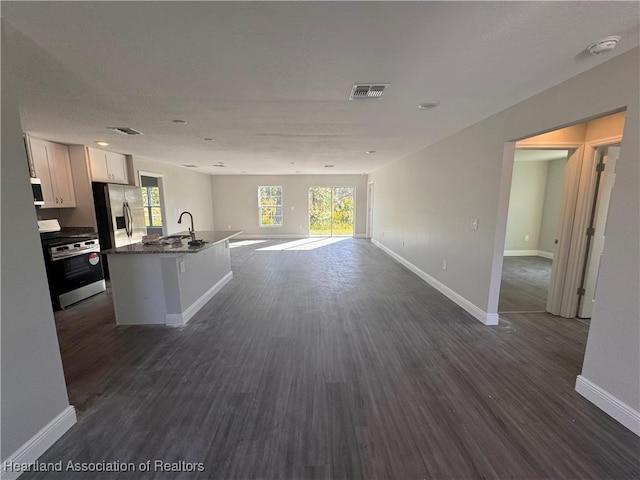 unfurnished living room with dark hardwood / wood-style flooring and sink