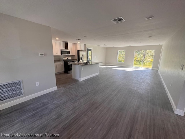 unfurnished living room with dark hardwood / wood-style floors