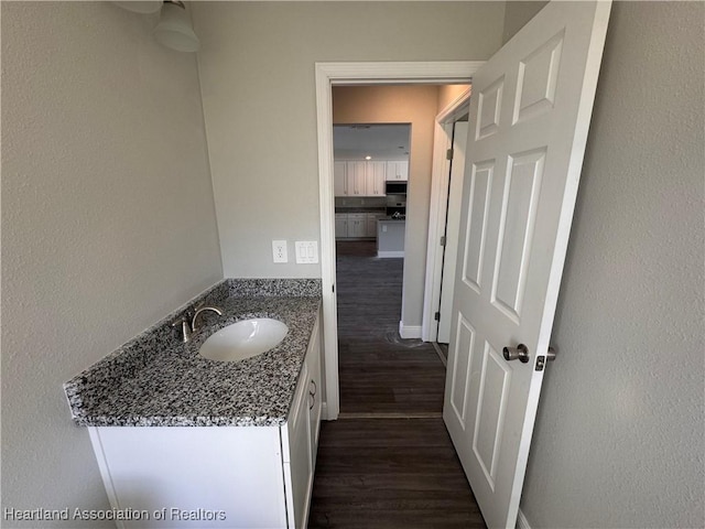 bathroom with vanity and hardwood / wood-style floors