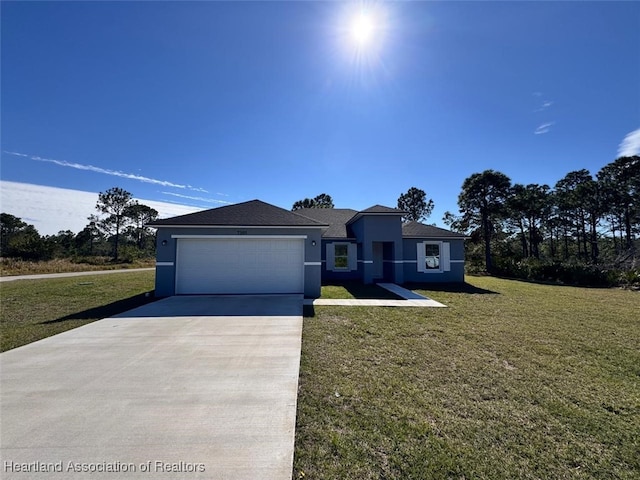 view of front of property with a garage and a front yard