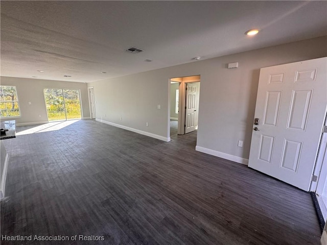 unfurnished room with dark hardwood / wood-style floors