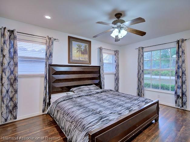 bedroom featuring recessed lighting, a ceiling fan, baseboards, and wood finished floors