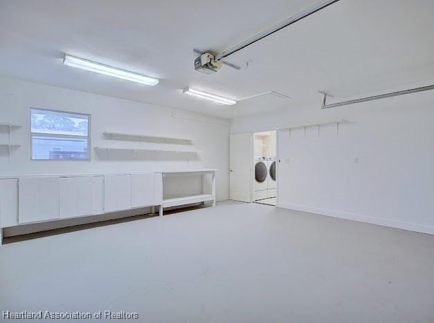 garage featuring a garage door opener and separate washer and dryer