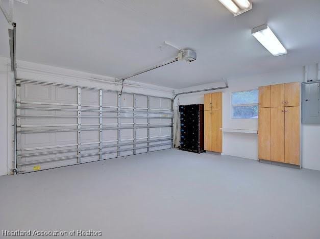 garage with electric panel and a garage door opener