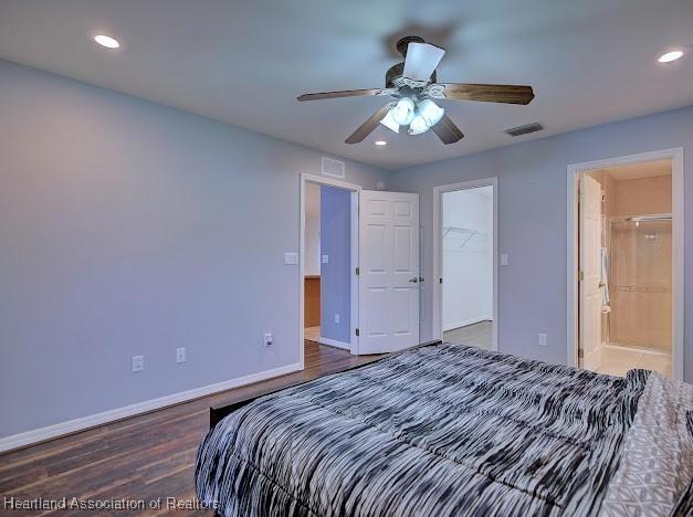 bedroom with recessed lighting, wood finished floors, visible vents, and baseboards