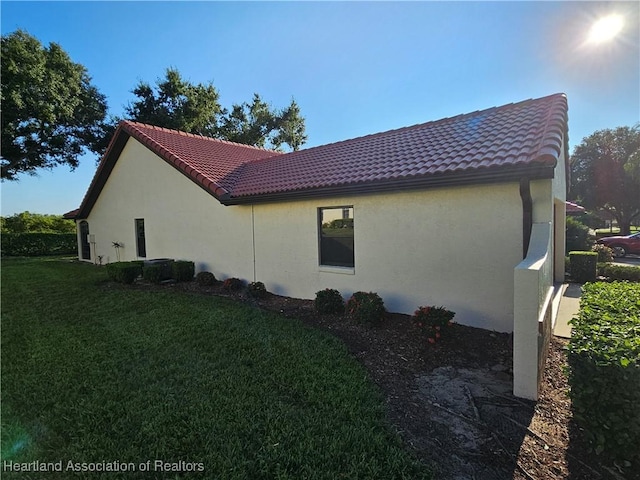 view of property exterior featuring a lawn