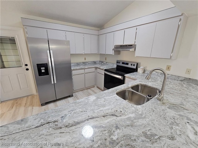 kitchen featuring stainless steel appliances, white cabinetry, lofted ceiling, and sink