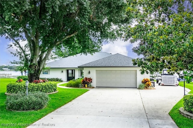 130 Deanna Dr, Lake Placid, FL 33852 - single story home featuring concrete driveway, a garage, roof with shingles, stucco siding, and a front yard