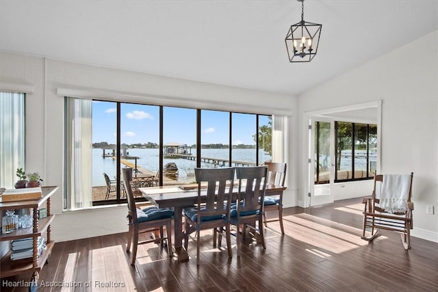 130 Deanna Dr, Lake Placid, FL 33852 - dining area with dark wood finished floors, healthy amount of natural light, a chandelier, a water view, and lofted ceiling