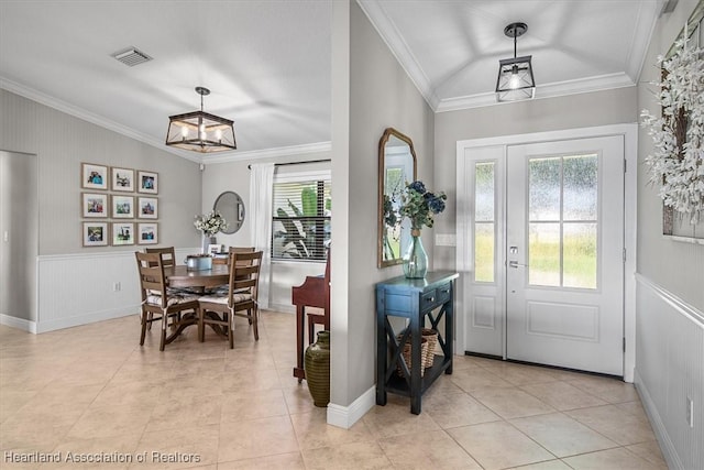 130 Deanna Dr, Lake Placid, FL 33852 - foyer entrance with plenty of natural light, ornamental molding, light tile patterned floors, and a wainscoted wall